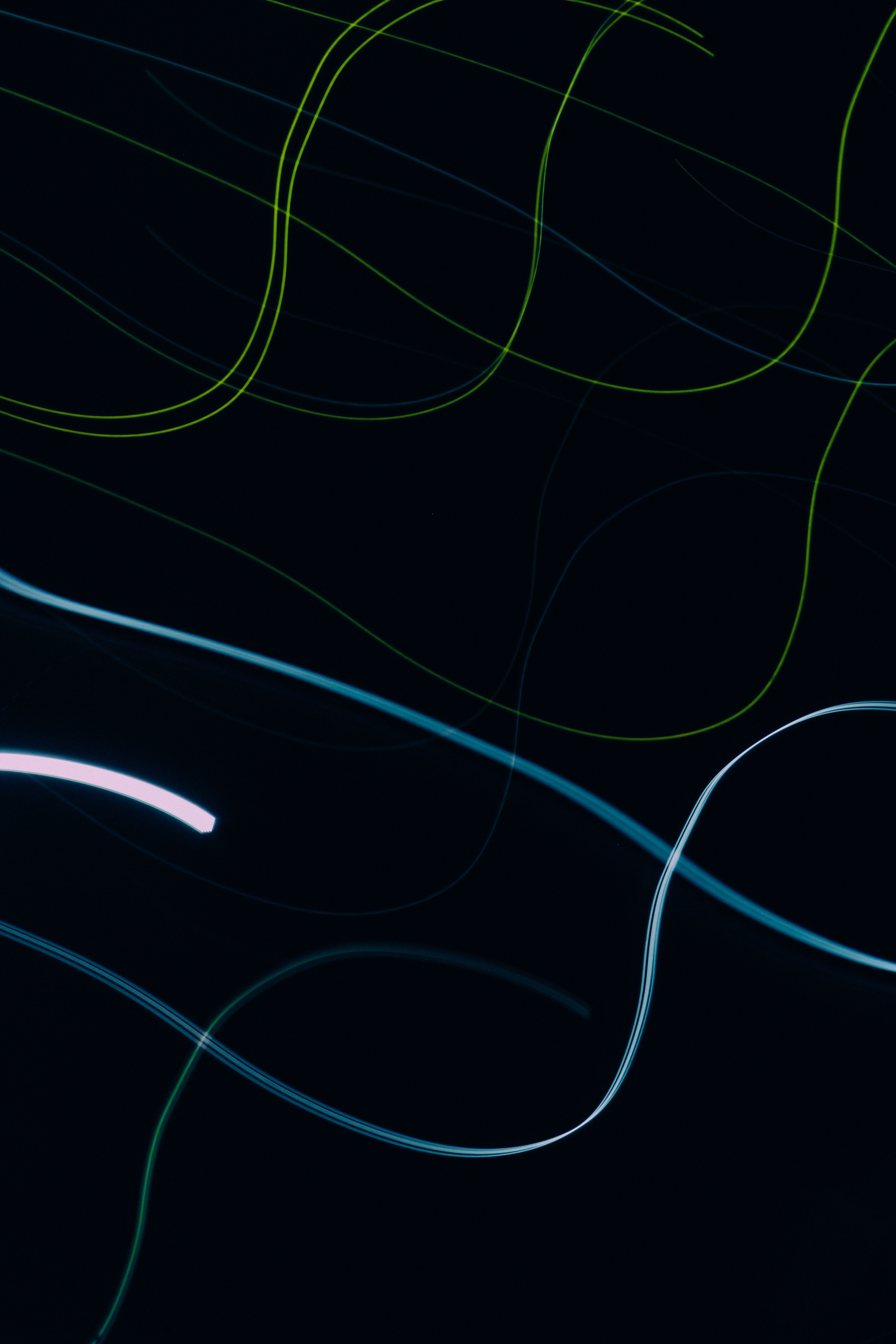 Vertical neon lines in red, green and blue against black.